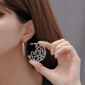 Chic silver hollow floral C-hoop earrings with micro-pave diamonds on model