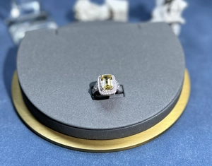 Detailed top view of a sterling silver halo ring featuring a large yellow rectangle gem