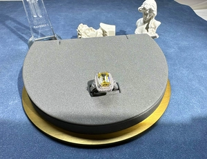 Macro shot of silver ring featuring a large rectangular yellow gemstone and side diamonds