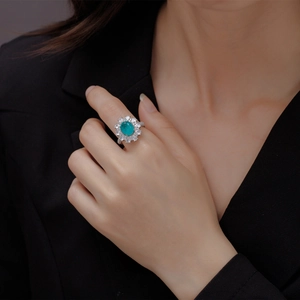 Luxurious oval Paraiba tourmaline ring with double halo diamond cluster setting