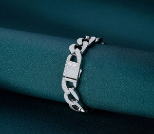 Close-up of a silver Cuban link bracelet with full pave-set zircon and box clasp detail
