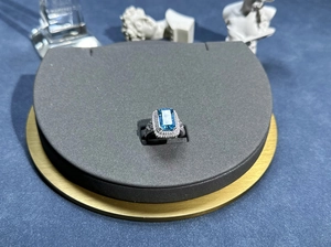 Macro shot of 8x12mm emerald-cut aquamarine halo ring with brilliant pavé accents