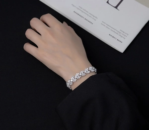 Gros plan d'un bracelet fleuri élégant avec diamants baguette sur un poignet