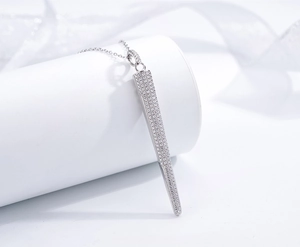 Macro shot of silver tapered cone pendant with micro-pave crystals on link chain