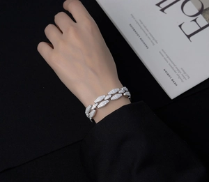 Close-up of silver geometric Cuban link bracelet with micro-pave white zircons on wrist