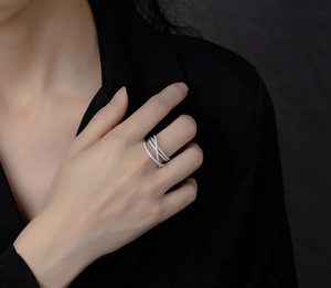 Macro shot of s925 silver criss-cross ring with micro-pave white cubic zirconia on a model