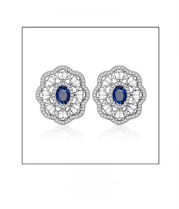 Detail of flower cluster earrings with oval blue sapphire and micro-pave diamonds