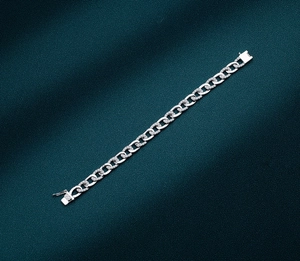 Detailed shot of polished sterling silver Cuban chain with shimmering cubic zirconia stones