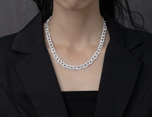 Close-up of pavé crystal Cuban chain necklace in sterling silver on model neck