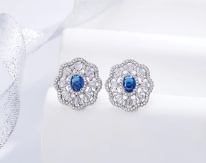 Macro detail of oval sapphire flower earrings in 925 sterling silver with sparkling diamonds