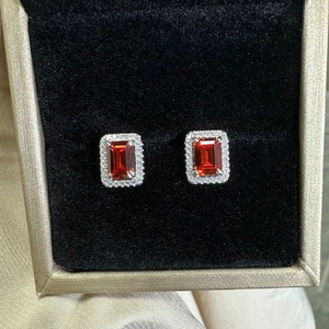 Elegant 925 sterling silver studs featuring emerald-cut ruby stones with halo diamond