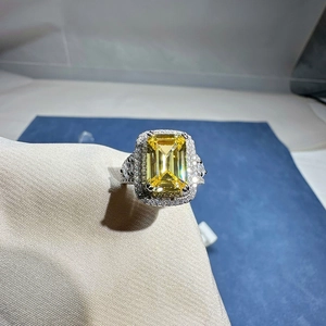 Elegant emerald cut yellow gemstone halo ring with pave diamonds on silver band
