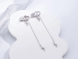 Detail of silver S925 cloud lightning earrings with sparkling pavé micro-inlaid stones