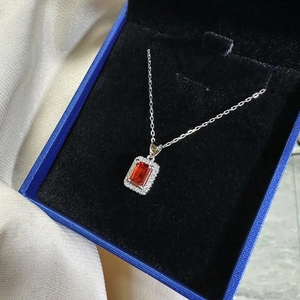 925 silver necklace featuring a rectangular orange-red ruby pendant with a diamond halo