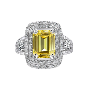 Emerald cut yellow gemstone ring with sparkling diamond halo in silver finish