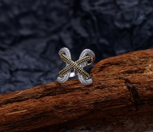 Detail of S925 silver criss-cross wide ring with pavé-set black and white stones