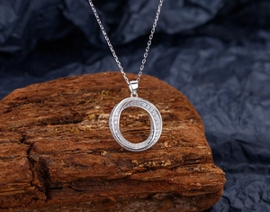 Macro detail of S925 sterling silver Mobius pendant necklace with pave-set cubic zirconia