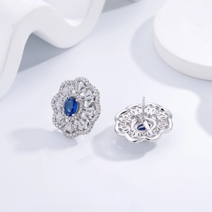 Elegant 925 silver stud earrings with oval blue sapphire and pavé diamond halo