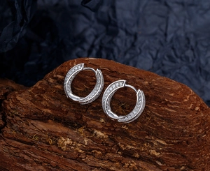 Macro shot of silver Mobius hoop earrings with shimmering pavé micro-inlaid zircon stones