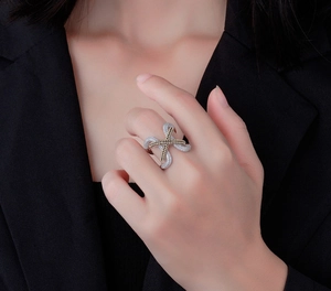 Detail of S925 silver criss-cross ring with pavé diamonds on a model hand