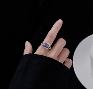 Macro detail of silver ring featuring a 7.5mm purple crystal and flower micropave