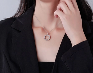 Close-up of Mobius double ring necklace in S925 silver with sparkling zircon pavé setting