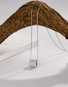 Detail of S925 silver cylinder pendant with micro-pave crystals on twig branch