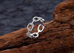 Macro view of interlocking silver link rings paved with sparkling micro-zirconia stones