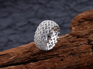 Macro shot of V-shaped hollow sterling silver wide band ring with pavé-set diamonds