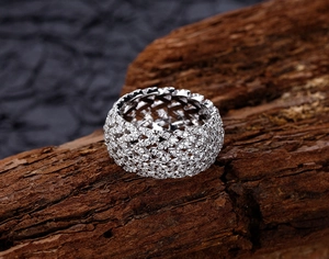 Detailed shot of S925 sterling silver hollow wide ring with pavé-set zircons on bark