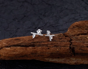 Detailed view of S925 silver earrings with sparkling zircon stones on a rustic wood base