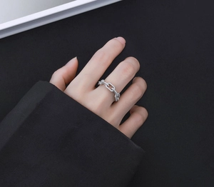 Detail of S925 sterling silver chain ring with pavé micro-inlaid zircon on model finger