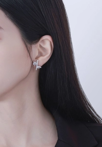 Detailed close-up of S925 silver irregular stud earrings with cubic zirconia on model