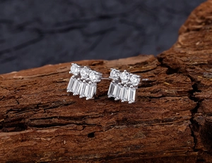 Macro shot of S925 silver stud earrings with sparkling round and baguette-cut zircons