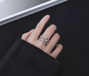 Detailed view of S925 silver wave ring featuring layered curves and pavé set cubic zirconia