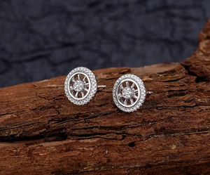 Macro detail of S925 sterling silver wheel stud earrings with pavé white zircon stones