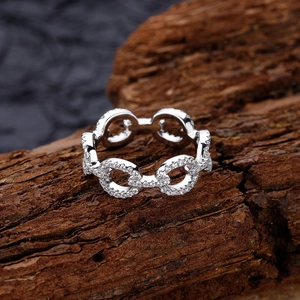 925 silver link chain ring with pave-set cubic zirconia on textured wood background