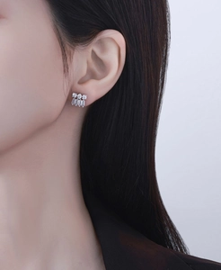 Macro shot of S925 sterling silver baguette-cut cubic zirconia tassel stud earrings