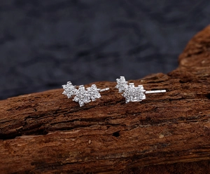 Macro view of S925 sterling silver snowflake stud earrings with white cubic zirconia