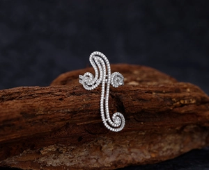 Detailed view of S925 sterling silver swirl ring with pavé zircons on natural tree bark