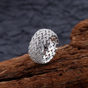 Wide V-shaped openwork S925 silver ring with full micro-pave crystals on wooden block