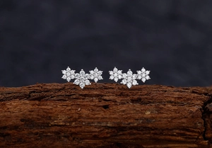 Macro view of S925 sterling silver snowflake cluster earrings with cubic zirconia inlay