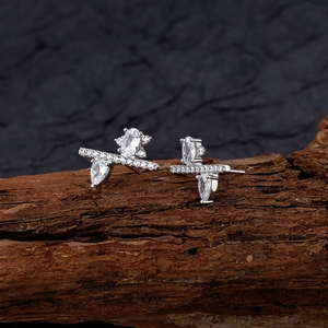 Irregular S925 sterling silver stud earrings with cubic zirconia on textured wood background