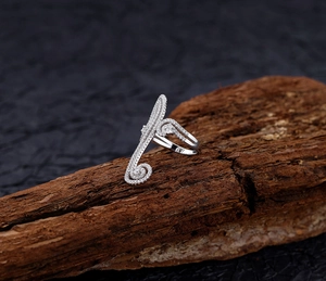 Macro detail of S925 sterling silver swirl ring with pavé-set zircons on rustic wood