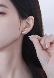 Close-up of S925 sterling silver snowflake stud earrings with sparkling cubic zirconia