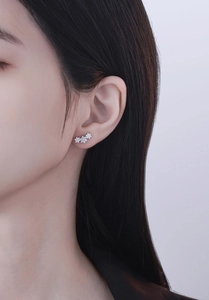 Close-up of S925 sterling silver snowflake crawler earrings with sparkling zircons