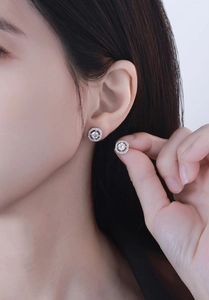 Detailed view of square halo diamond stud earrings in S925 sterling silver on ear