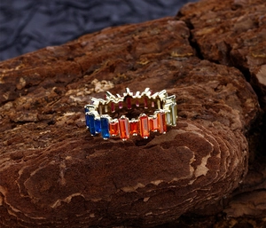 Close-up of rainbow baguette-cut gemstones set in a gold-plated S925 silver ring band
