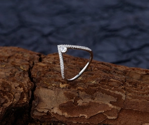 Macro view of V-shaped S925 sterling silver ring with pear-cut drop and micro-pave diamonds