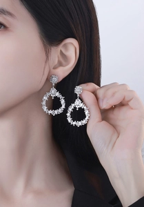 Close-up of luxury S925 silver drop earrings with brilliant cubic zirconia crystals